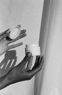 A person's hands holding Hanacure product