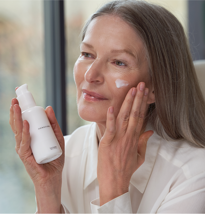 Woman holding a Hanacure brush near her face