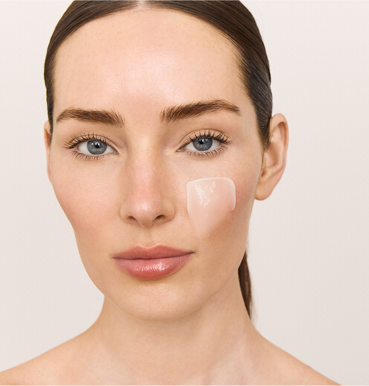 Woman holding a Hanacure brush near her face